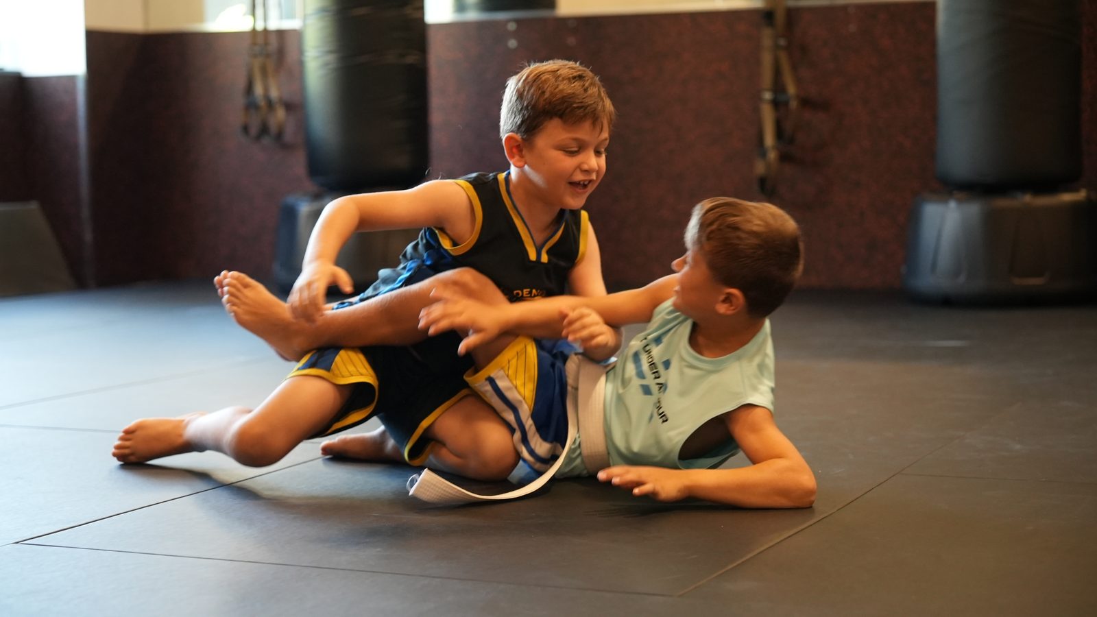 Two campers laughing during a grappling game