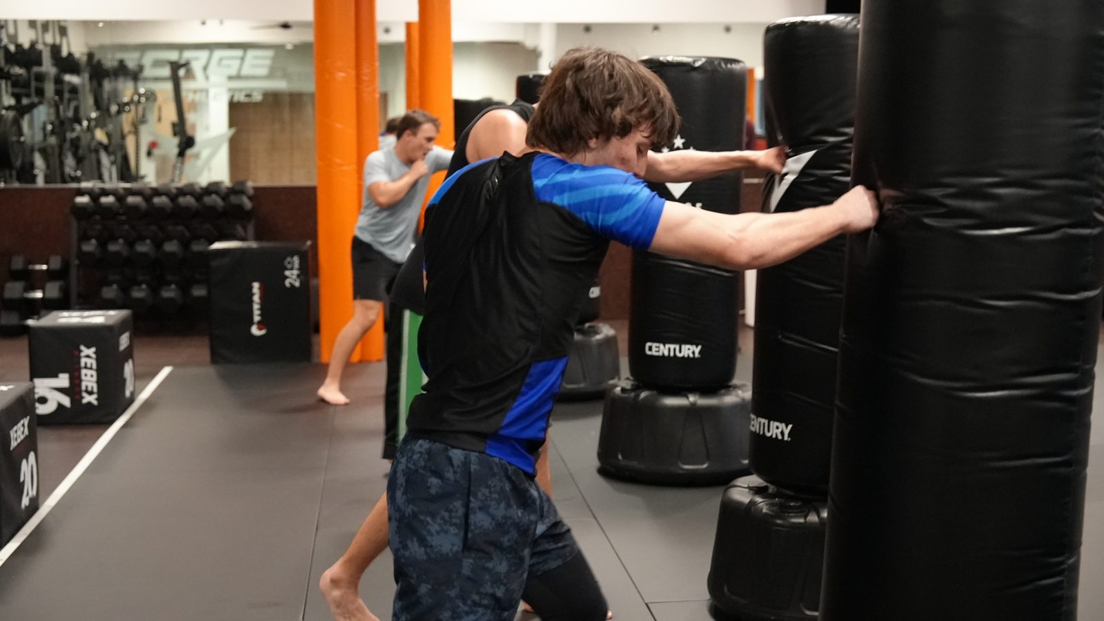 A member driving a punch into the heavy bag