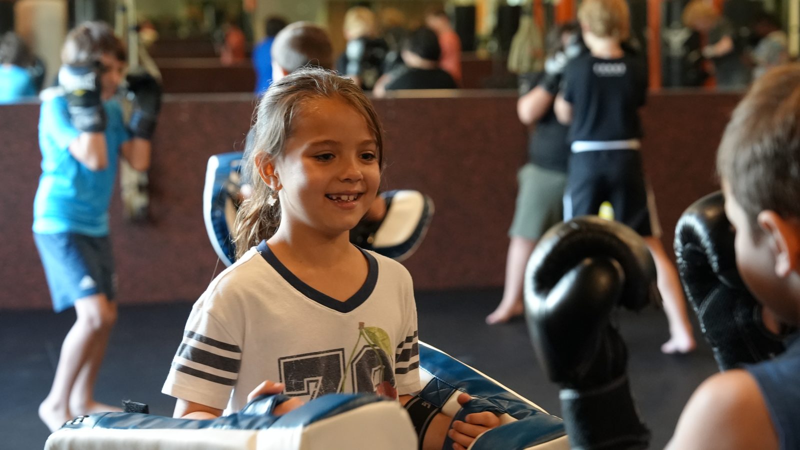 Young student smiling during a partner drill