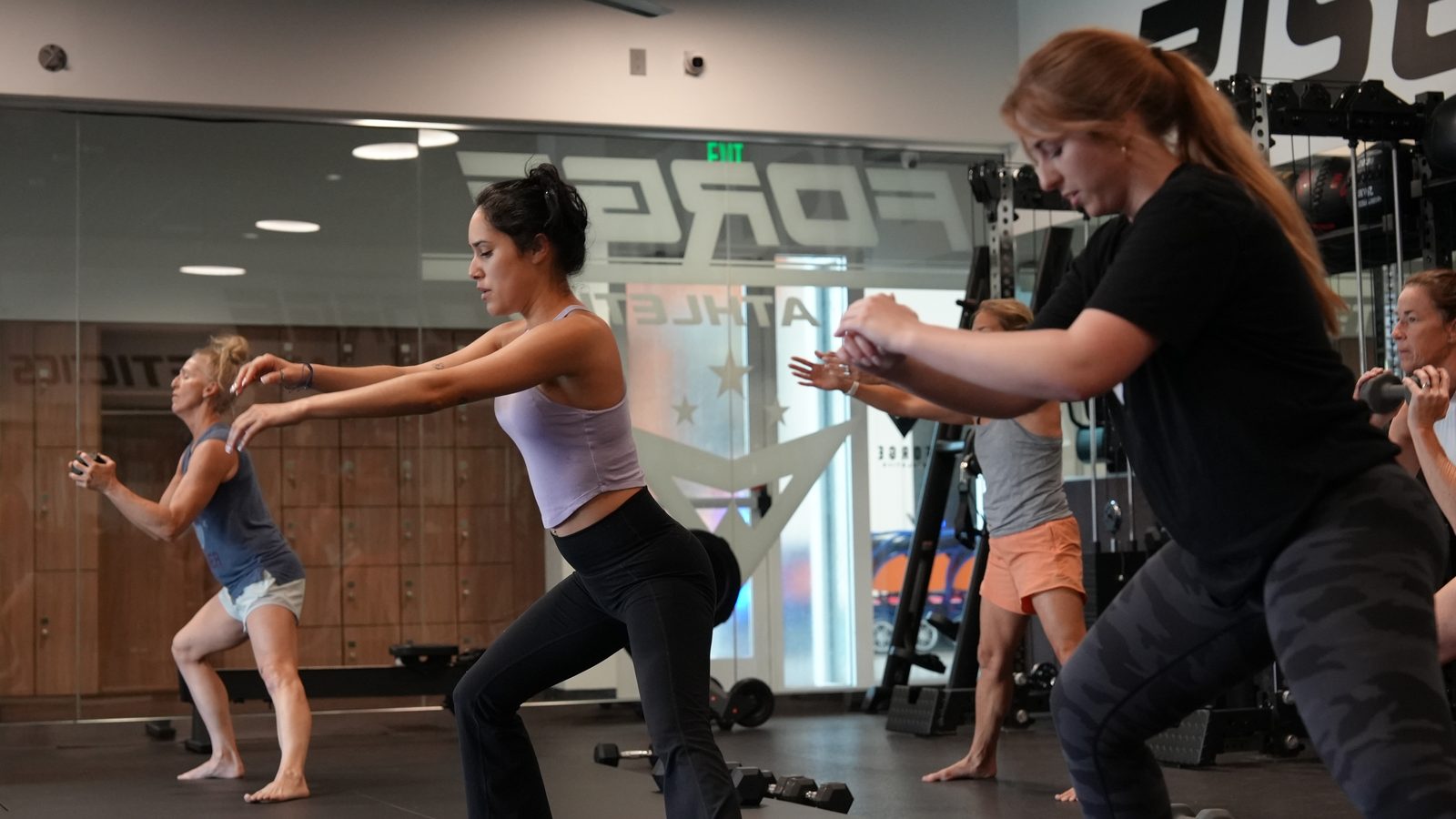 The morning strength class working through a squat set