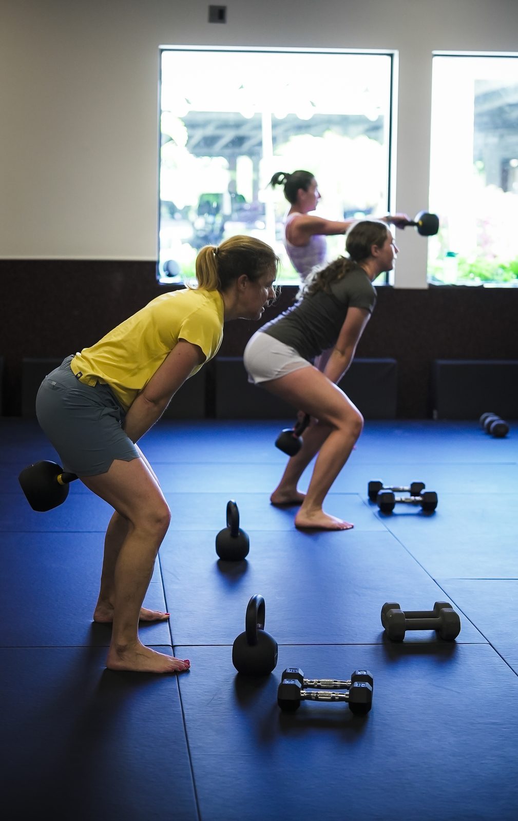 Members lift dumbbells during the Women's Only Strength and Kickboxing morning class at Forge Athletics