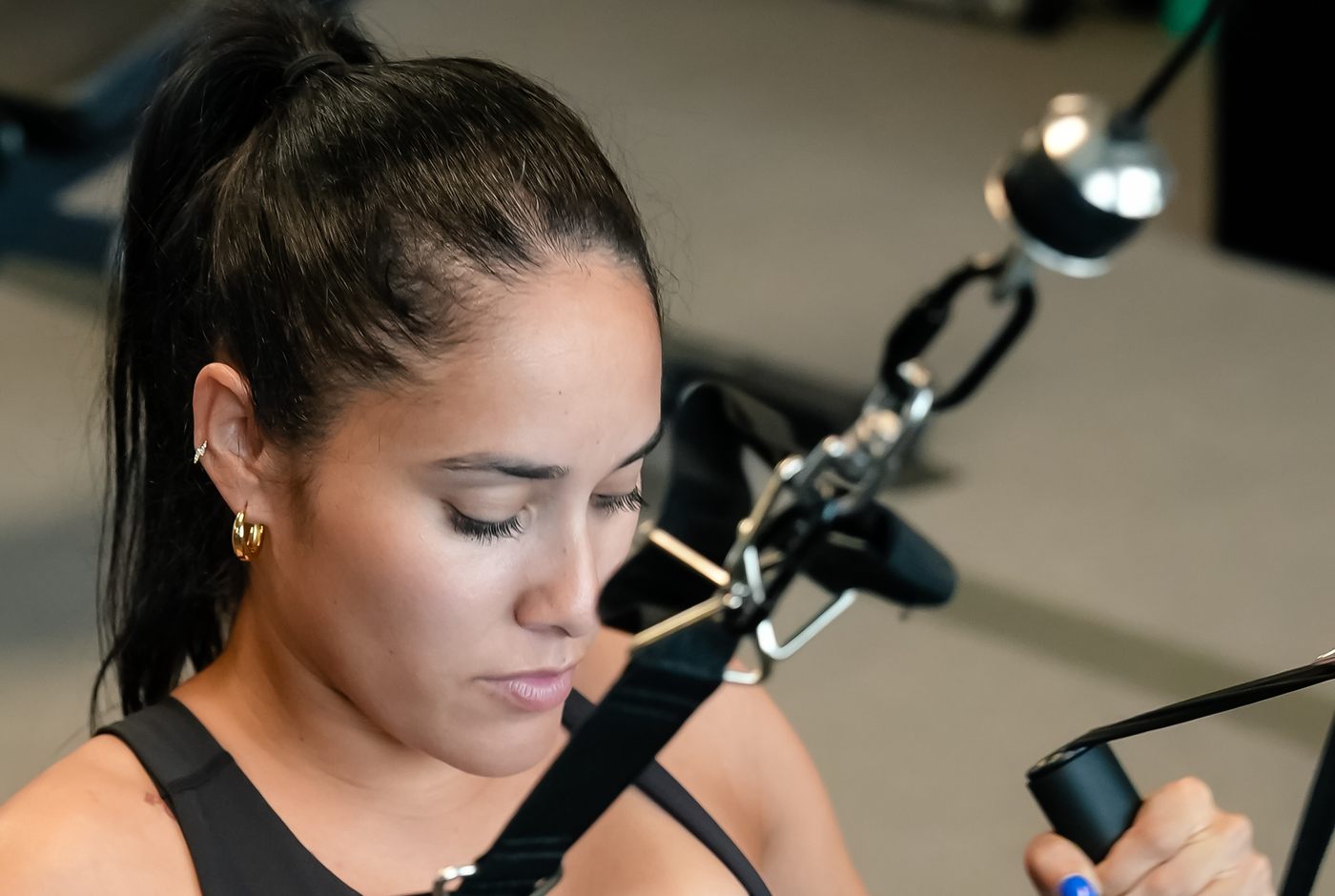 A member works through a cable-machine row during a coached strength session at Forge Athletics in Naples