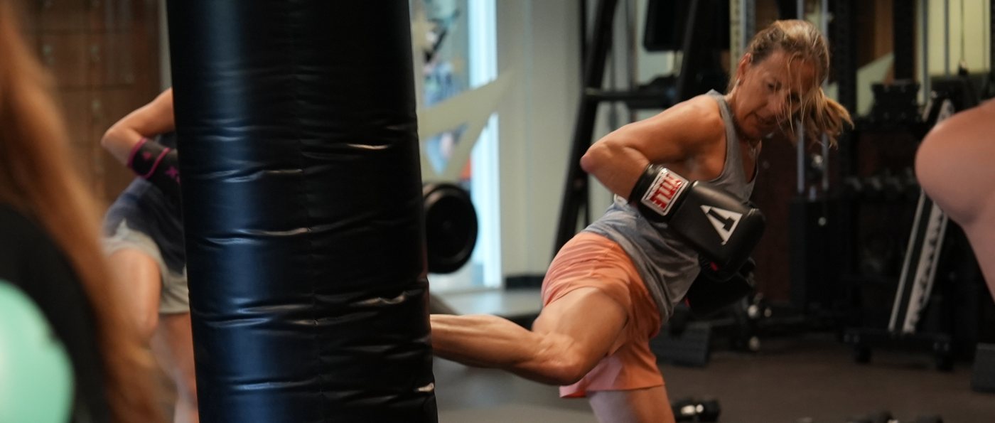 Members work the heavy bag line in Women's Only Kickboxing at Forge Athletics in Naples