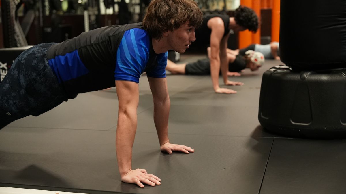 Teens hold a push-up position during the conditioning block of Youth MMA and Athletic Training at Forge Athletics