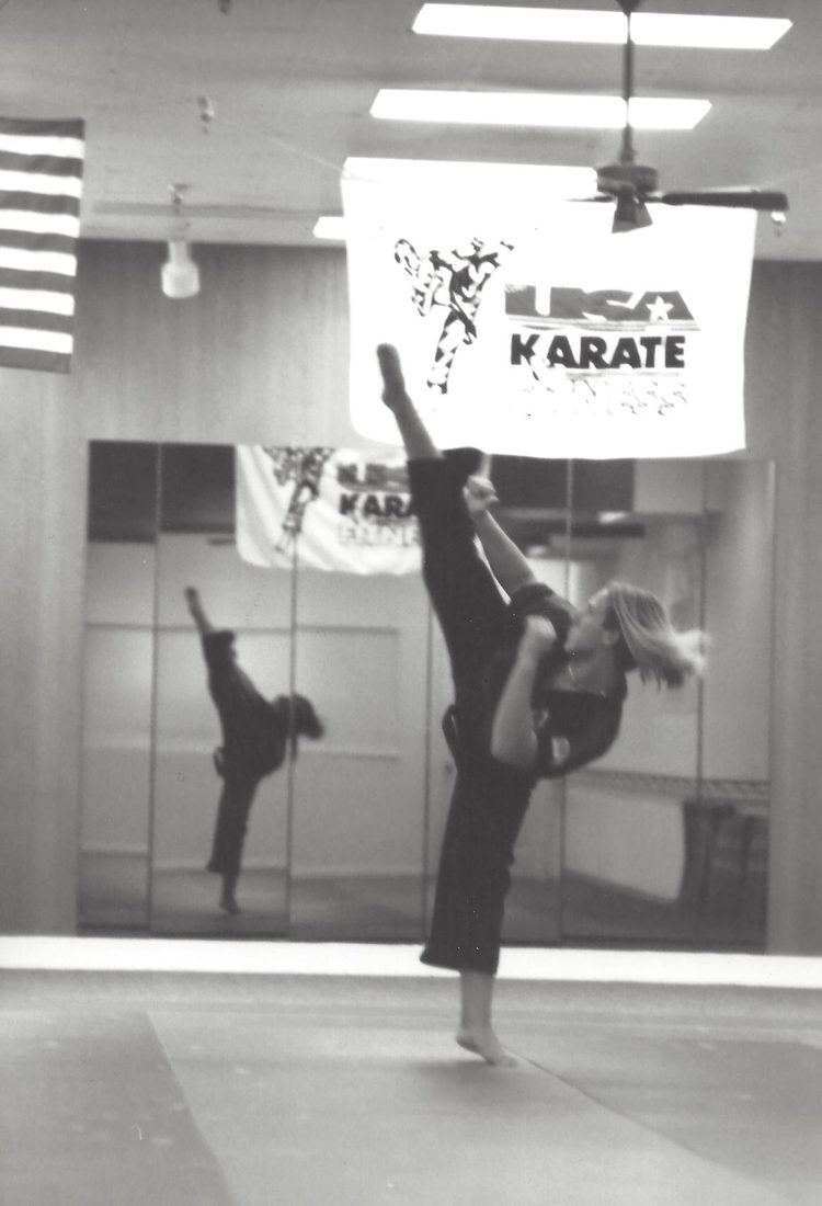 Sixteen-year-old Wil Pino throwing a high round kick at the Coastland Center mall dojo