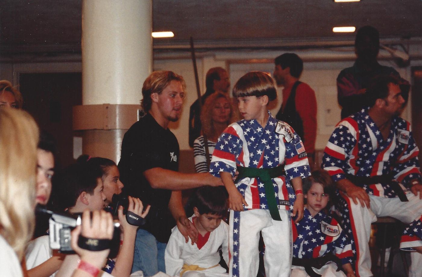 Eighteen-year-old Wil Pino coaching his young students at a martial arts competition