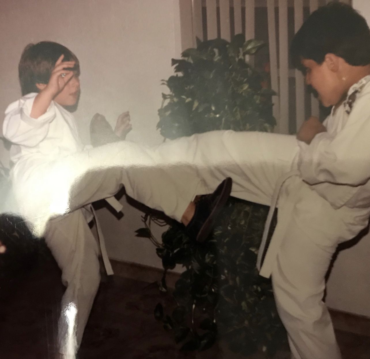 Young Wil Pino throws a kick while sparring his cousin Eli at home in their first days of training