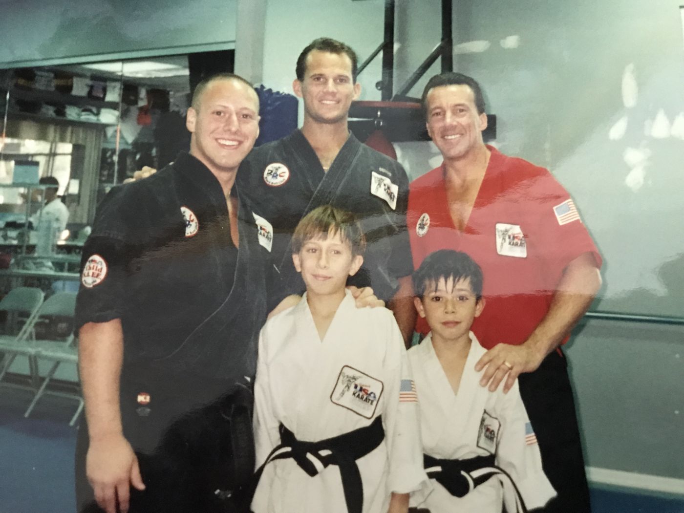 Wil Pino and fellow instructor Steve with Robert Fletcher and two young students receiving their black belts