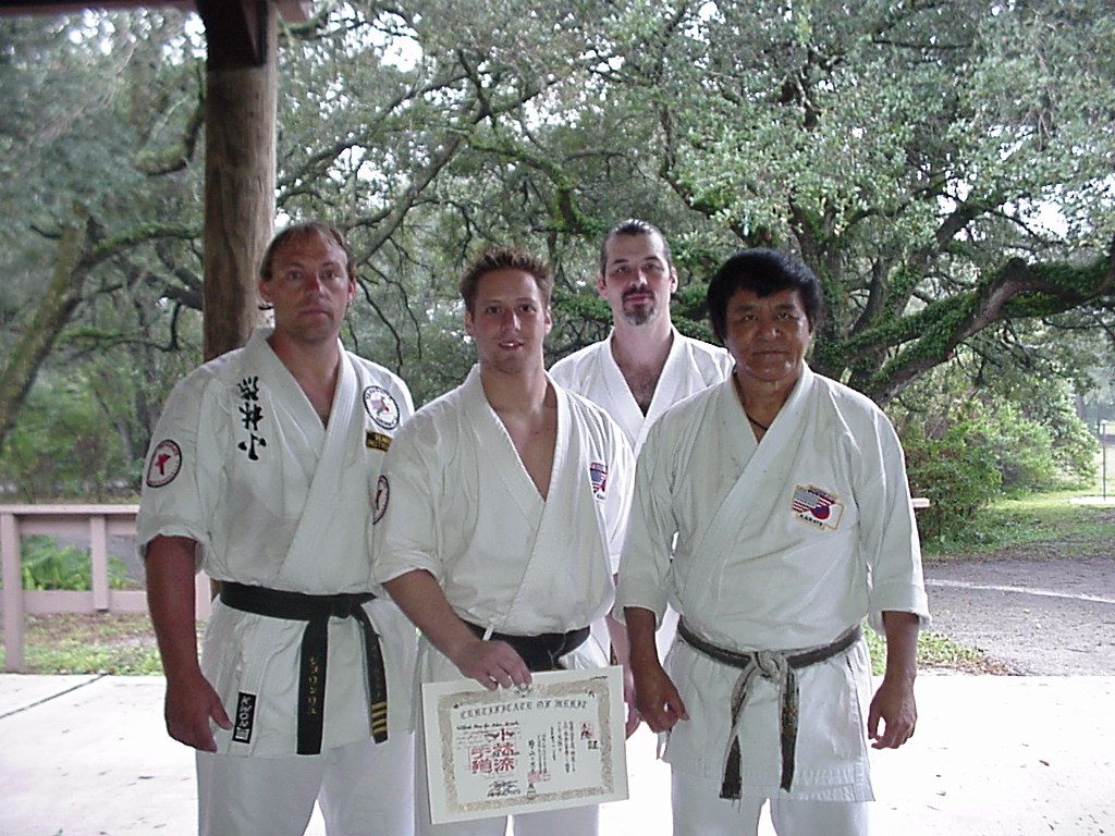 Wil Pino holding his third-dan Shorin-Ryu certificate beside Tadashi Yamashita, with Master Bryan Lentz and Sensei Lee