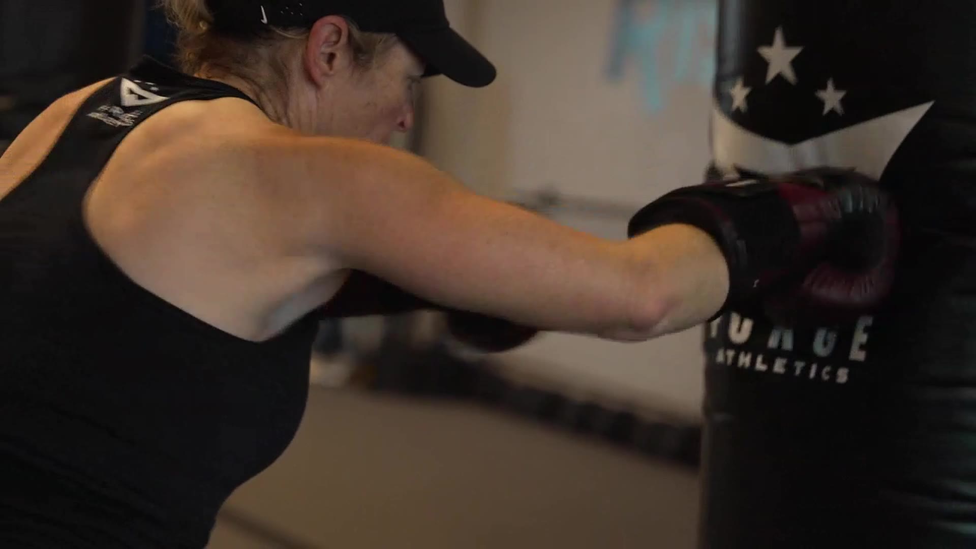 A member drives a punch into the Forge Athletics heavy bag during training in Naples